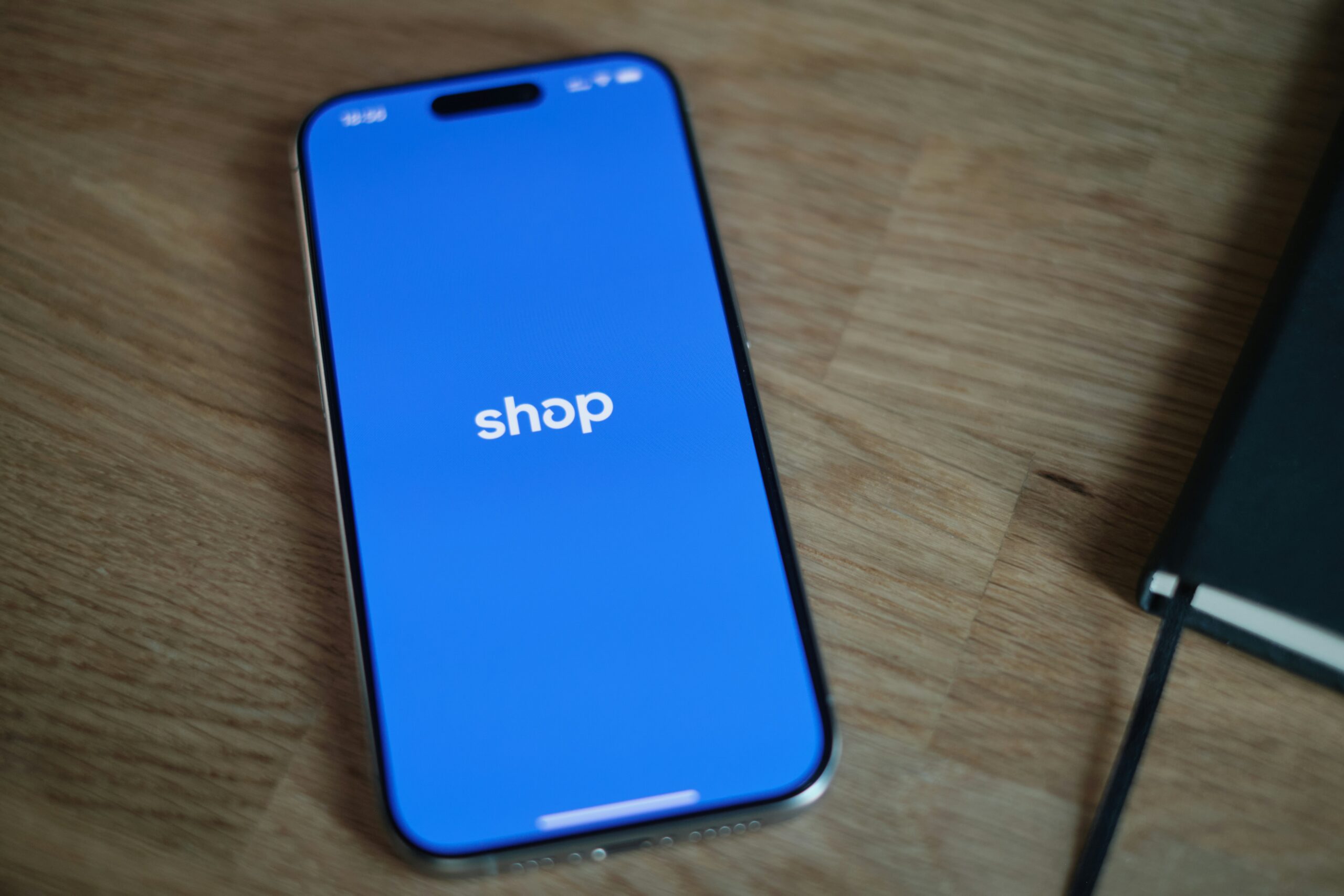 A cell phone sitting on top of a wooden table